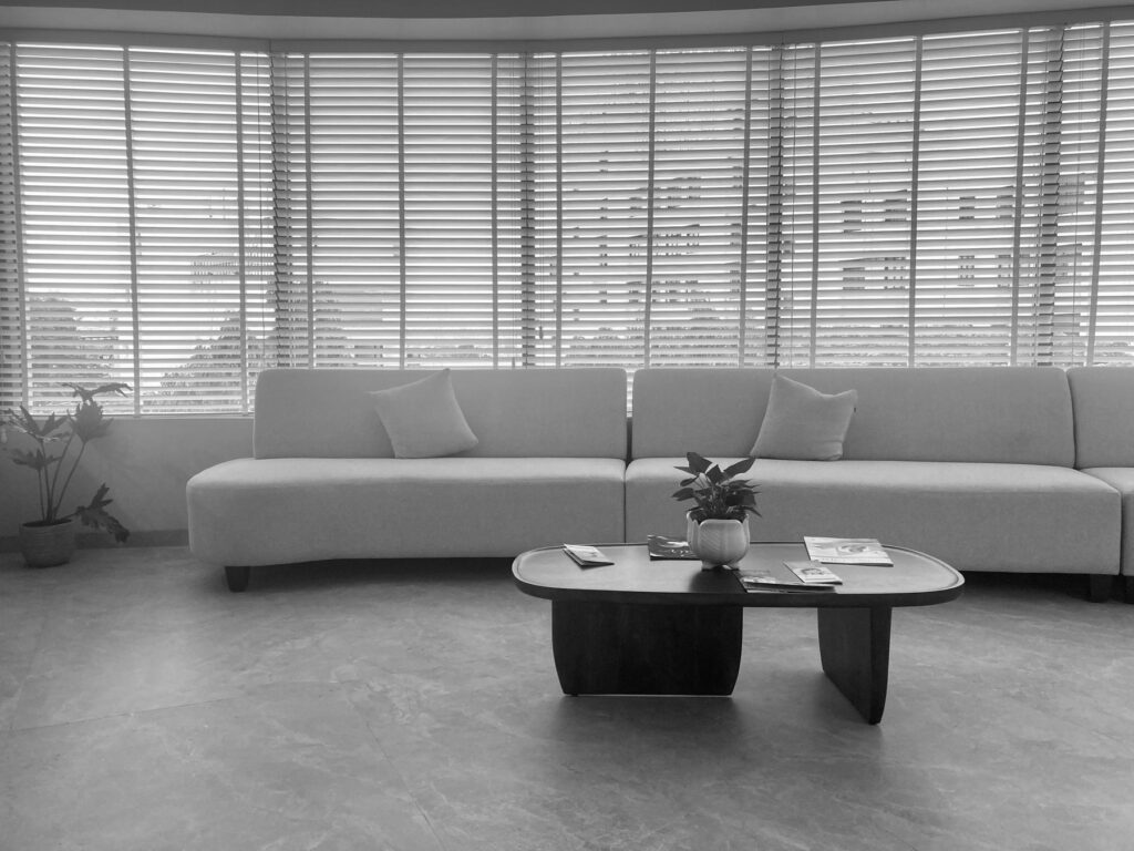 Modern living room with large windows and blinds
